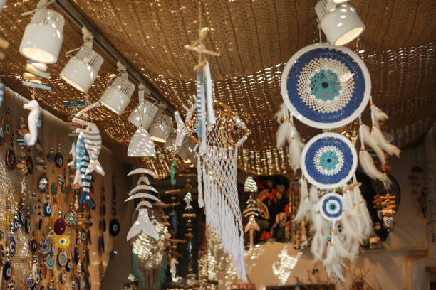 istock Various feather dream catchers made from the evil eye and souvenir magnets hanging on the walls and roof are sold in the market shop 2178119065