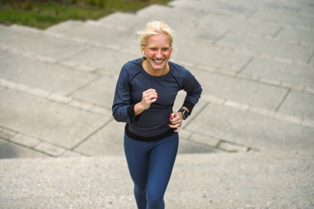 istock Woman enjoying a sprint outdoors, smiling confidently 2178123533