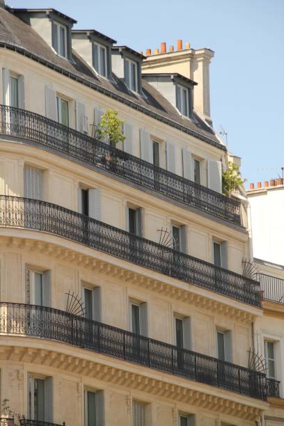 istock Classic Parisian building facade with wrought iron balconies and shuttered windows. 2178127086