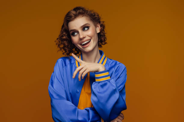 istock Playful Redheaded Woman in a Blue Jacket with a Lively Expression 2178129322