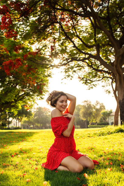 istock Sunlit Serenity: Woman in Red Dress Amidst Nature's Embrace 2178129708
