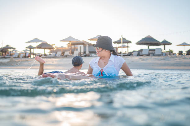 istock Mother and child in peaceful beachside water moment 2178131632