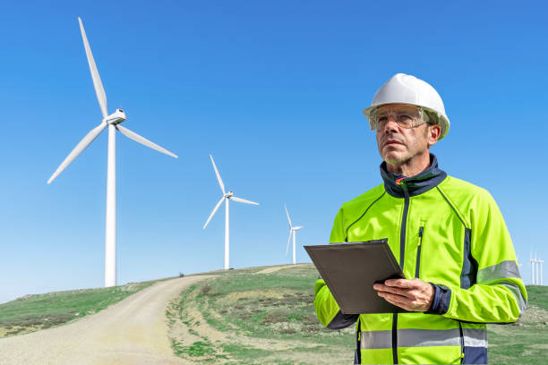 istock Technician with PPE inspecting wind turbines in a wind farm. 2178131853