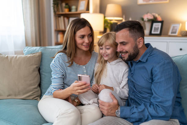 istock Cheerful family spending quality time with smartphone 2178132138