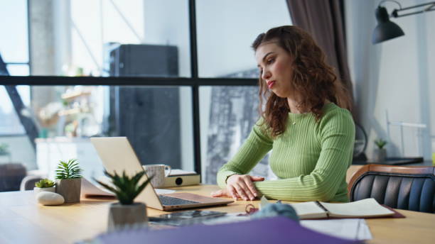 istock Sales manager talking online using laptop office closeup. Woman looking papers 2178132250