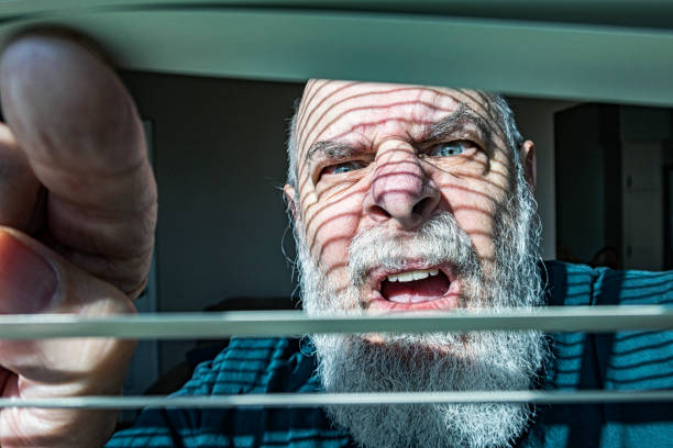Grumpy In Window 70+ Curious Senior Man Looking Through Window Stock Photos, Pictures ...