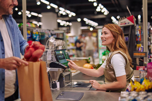 istock Friendly Customer and Cashier Interaction in a Supermarket Checkout 2178134479