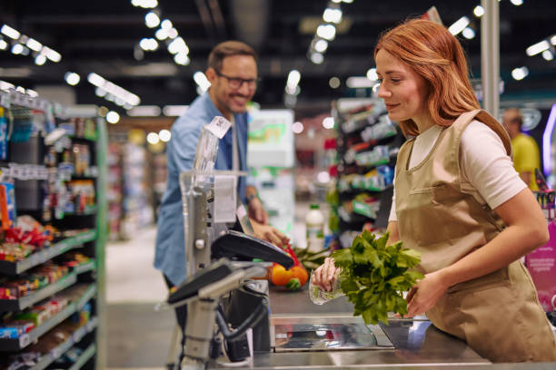 istock Grocery Store Interaction Between Friendly Cashier and Customer 2178134540