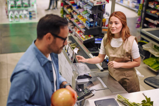 istock Friendly Customer and Cashier Interaction in a Supermarket Checkout 2178134561