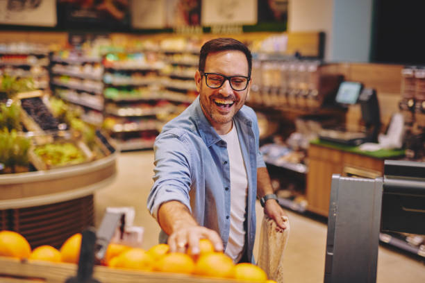 istock Man Shopping in Modern Supermarket's Fresh Produce Aisle 2178134859