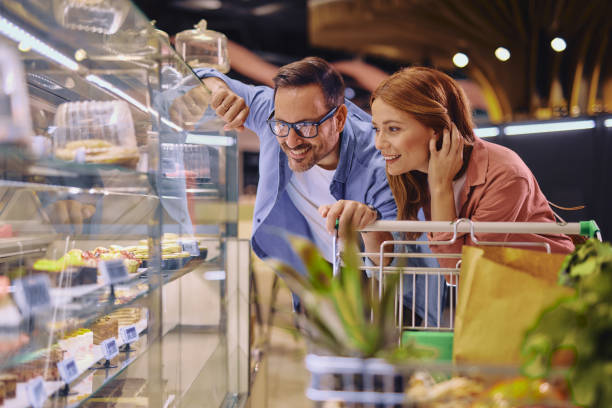 istock Young Couple Looking at Cakes in a Pastry Shop 2178135122
