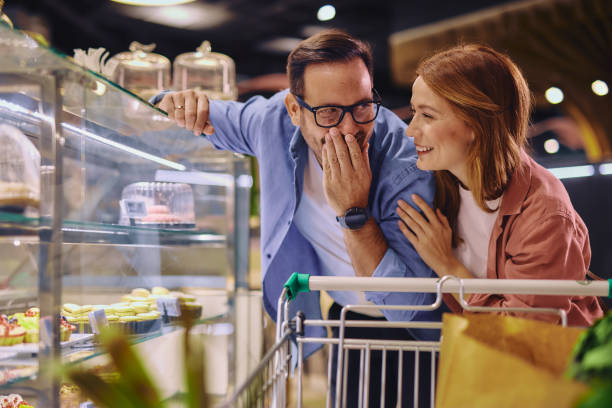 istock Young Couple Looking at Cakes in a Pastry Shop 2178135426