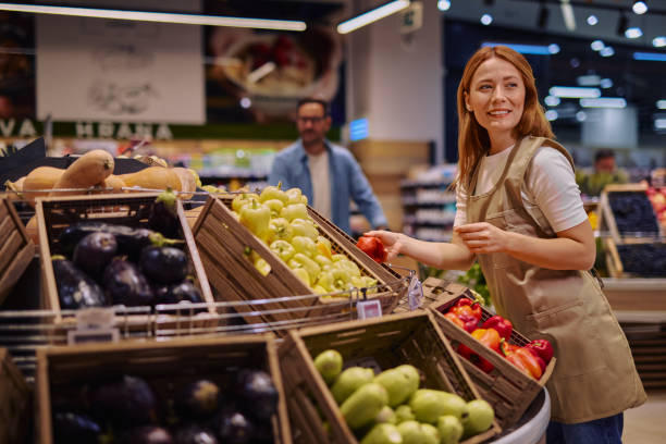 istock Friendly Grocery Store Woman Worker Assisting Customers with Fresh Produce 2178135556