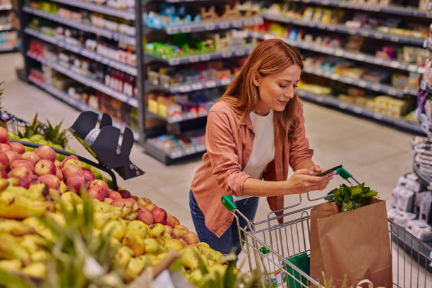 istock Purchasing Goods with Smartphone at Grocery Store 2178135580