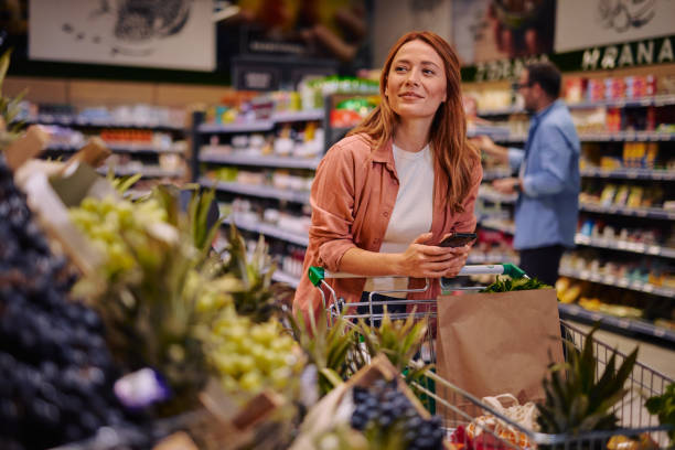 istock Purchasing Goods with Smartphone at Grocery Store 2178135620