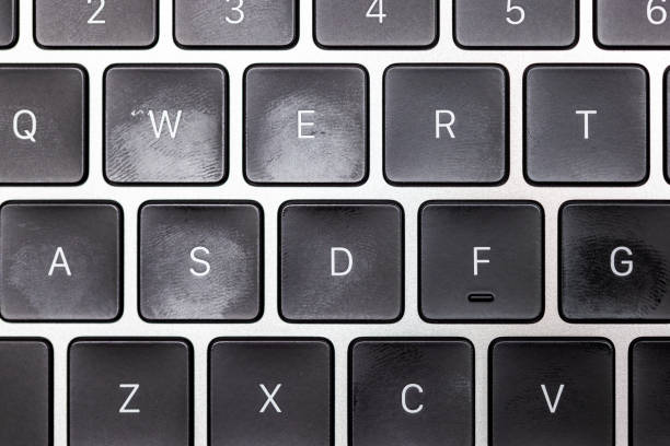 keyboard of famous silver colored laptop with fingerprints, closeup