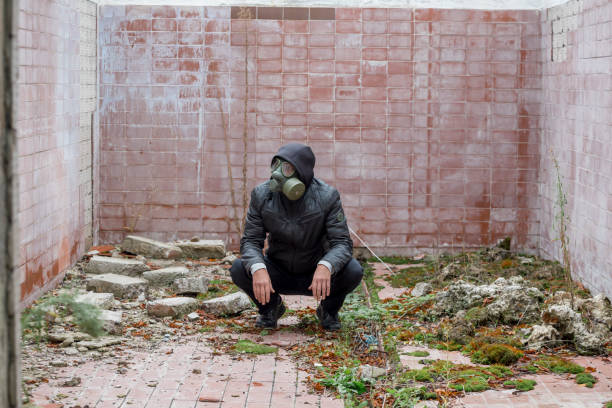 istock Apocalypse, man wearing gas mask at destroyed building 2178137263