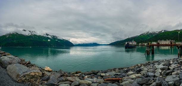 istock Panoramic view of a serene harbor with a docked ship. 2178137571