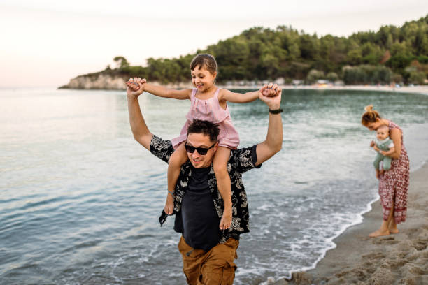 istock Family sharing some affection and love at the beach while enjoying walk. 2178141905