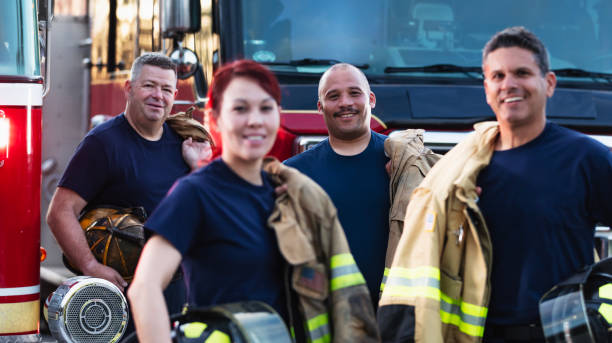 istock Multiracial group of four firefighters smiling at camera 2178143622