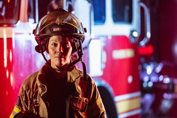 istock Female firefighter in protective gear  at night 2178143647