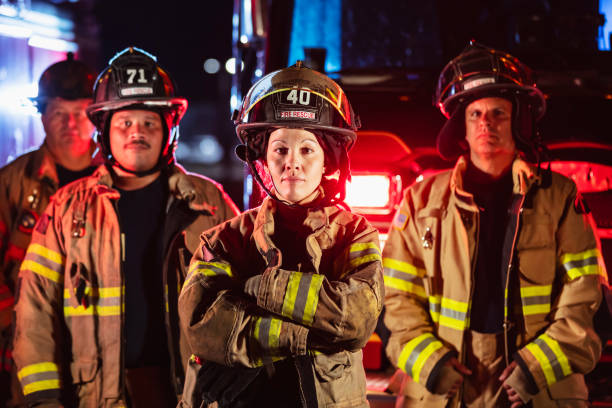 istock Female firefighter with group of firemen at night 2178143658