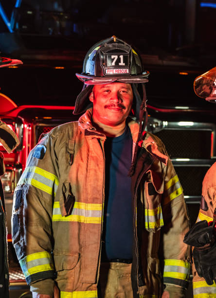 istock Mature multiracial fireman in protective gear at night 2178143675