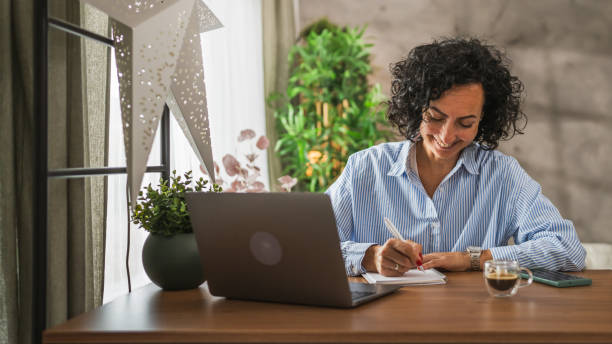 istock Mature caucasian woman work or learn use notebook and laptop from home 2178144235