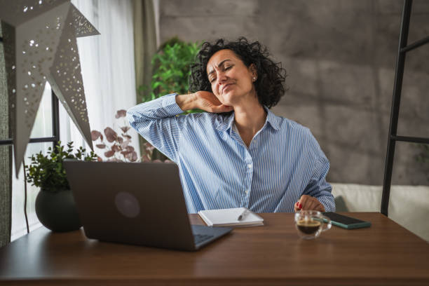 istock Mature woman work or learn use laptop while have neck pain 2178144237