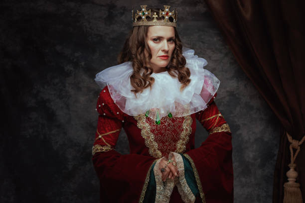 medieval queen in red dress with white collar and crown on dark gray background.