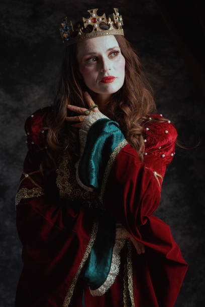 istock medieval queen in red dress with white makeup and crown 2178145210