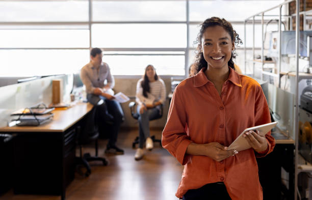 istock Happy woman using a digital tablet at a coworking office 2178146209