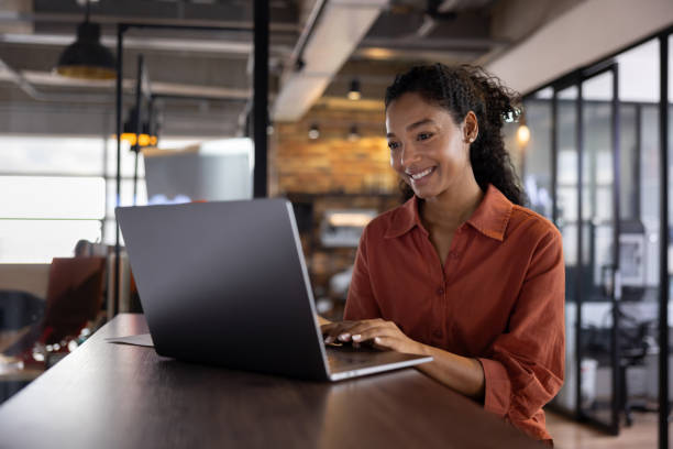 istock Happy businesswoman working at a coworking office using a laptop 2178146245