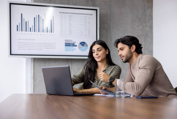Business team working together at the office using a laptop computer