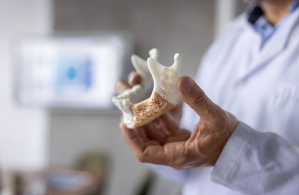 istock Close-up on a dentist looking at a dental implant 2178146279