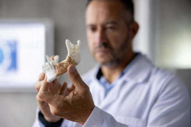 Orthodontist looking at dental aligner printed in 3D