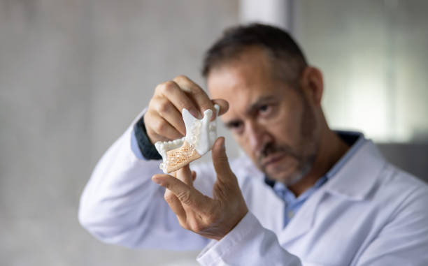 istock Dentist looking at dental aligner printed in 3D 2178146287