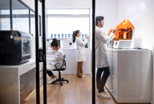 Healthcare workers printing 3D models at a laboratory Group of Latin American healthcare workers printing 3D models at a laboratory - Health technology concepts 3d printing lab stock pictures, royalty-free photos & images