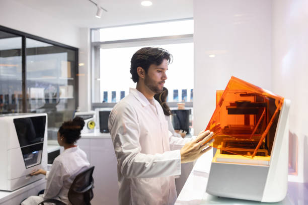 Team of health engineers bioprinting models at a 3D laboratory Latin American Team of health engineers bioprinting models at a 3D laboratory - healthcare and medicine concepts 3d printing lab stock pictures, royalty-free photos & images