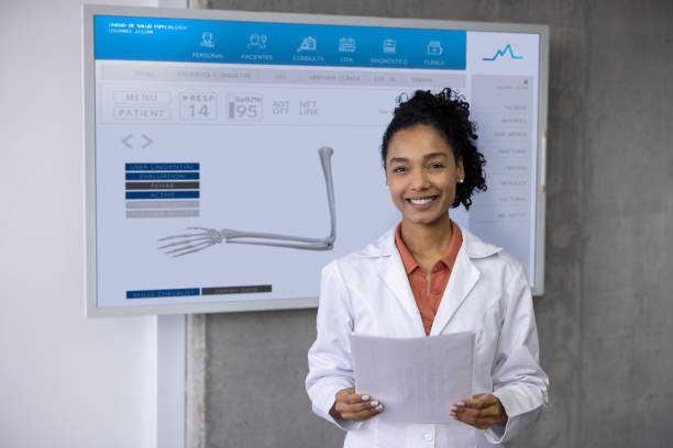 istock Orthopedist at her office showing an x-ray on a screen and smiling 2178146302
