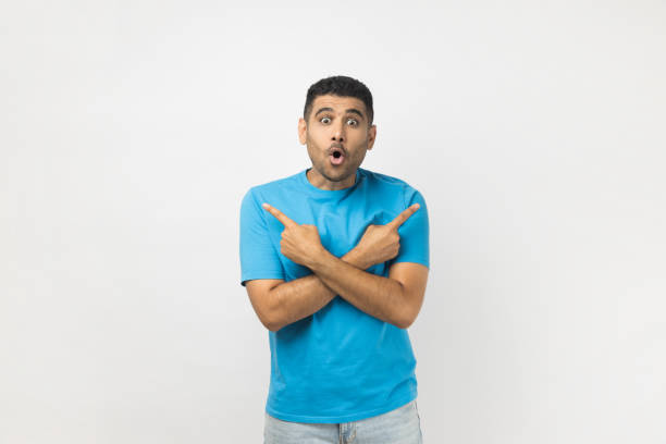 istock Shocked surprised astonished man standing pointing with index fingers to different size. 2178146874