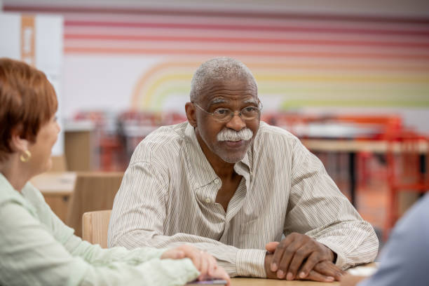 istock Senior man discusses retirement with spouse and financial planner 2178147568