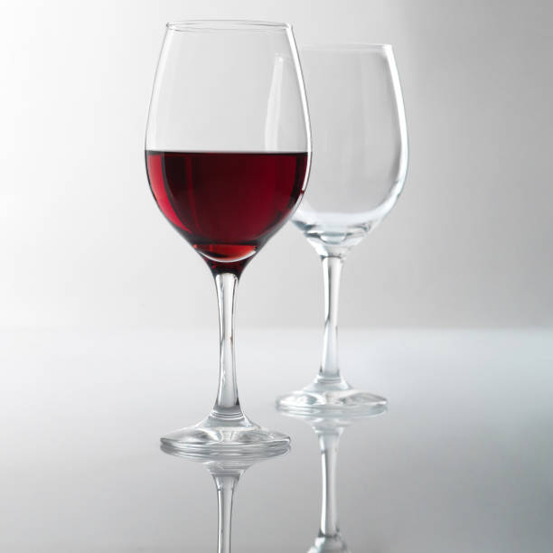 istock glass of white wine in studio with reflection on the table 2178148346