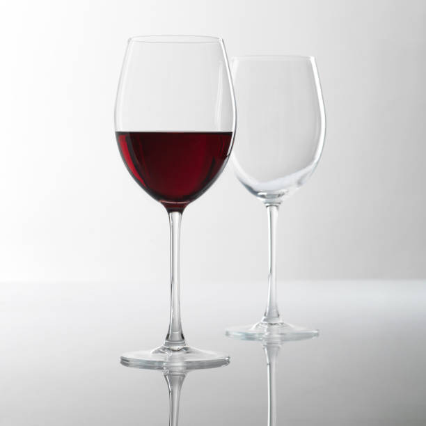 istock glass of white wine in studio with reflection on the table 2178148357