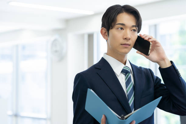 istock Businessman with smartphone in office 2178152129