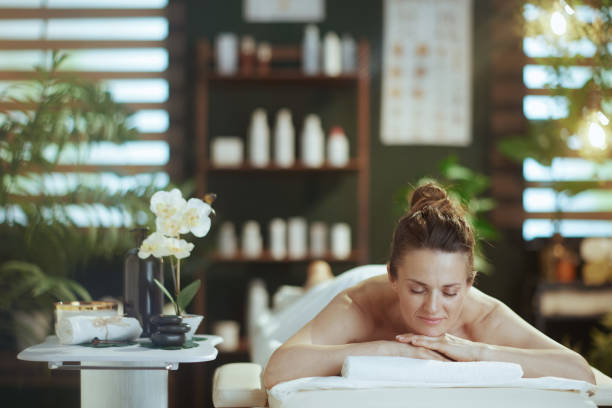 istock relaxed modern woman in massage cabinet laying on massage table 2178153277