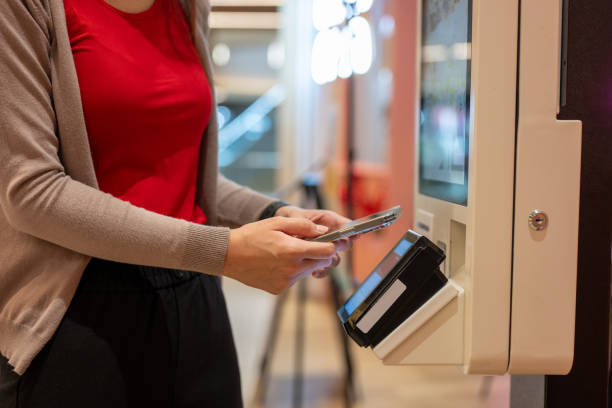 istock Woman paying at vending machine using smartphone 2178154937