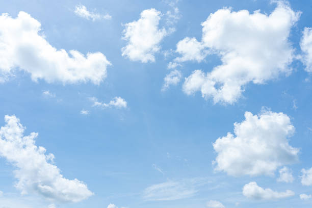 istock Fluffy white clouds drift across a clear blue sky, painting a breathtaking cloudscape 2178155076