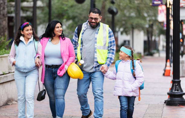 istock Hispanic parents walk children to school, on way to work 2178155884