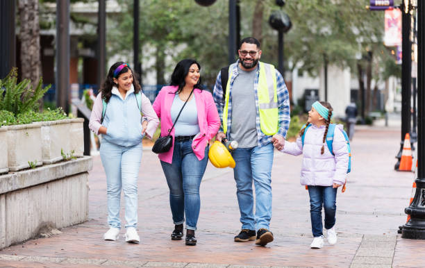 istock Hispanic parents walk children to school, on way to work 2178155885
